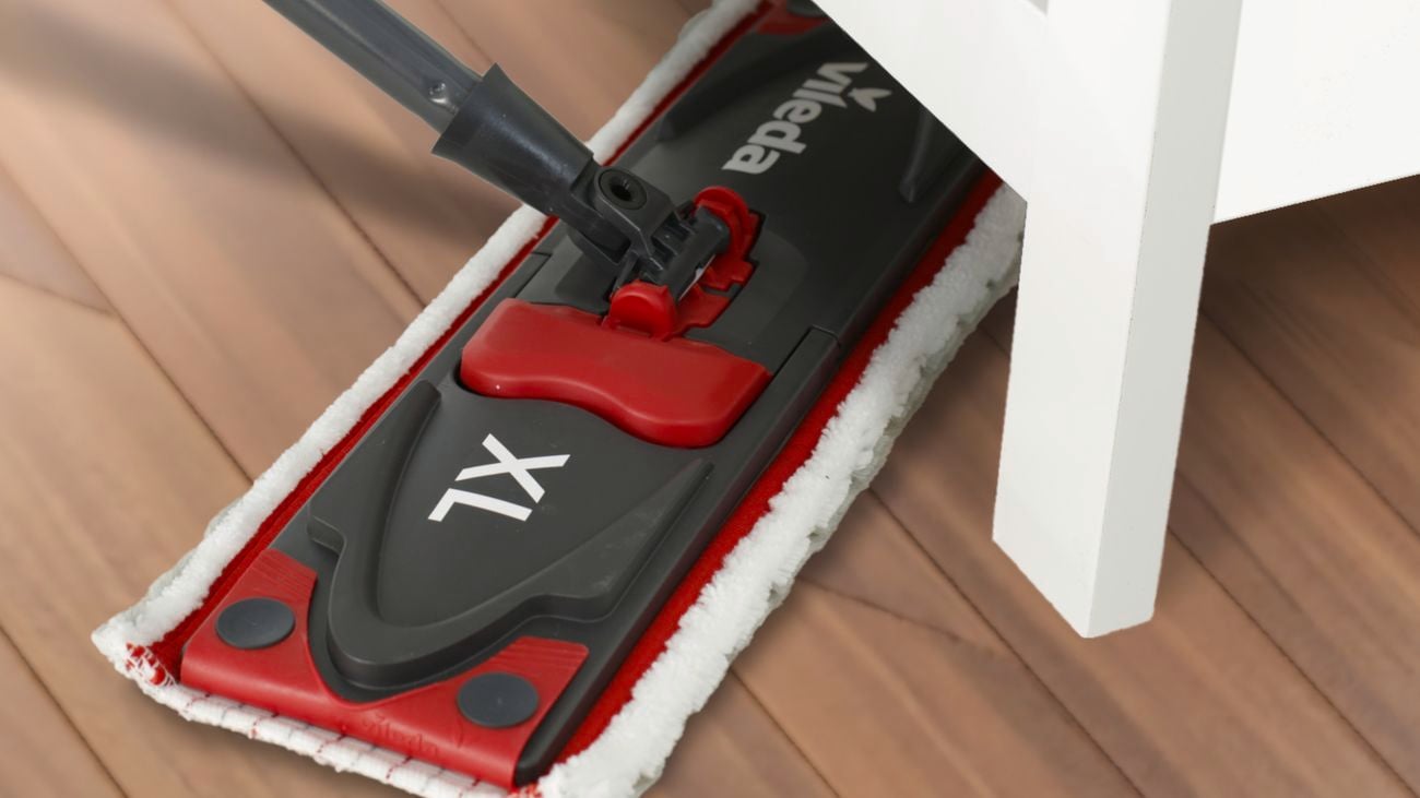 A mop being used to clean a hardwood floor