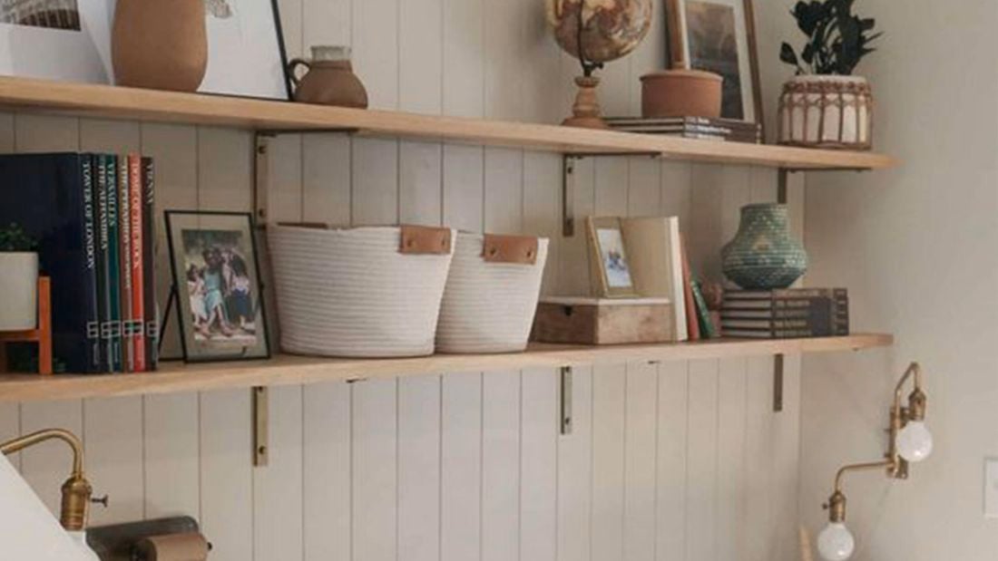 Home office with shelving on the wall