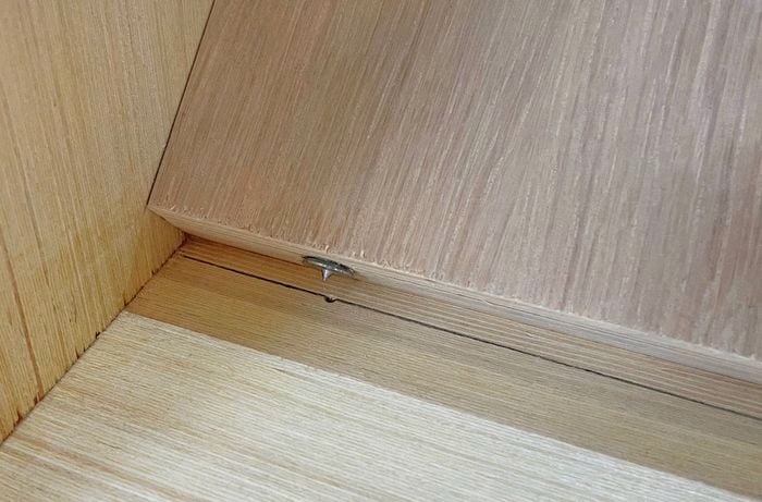 A panel with dowel centres is positioned over the centreline of another panel