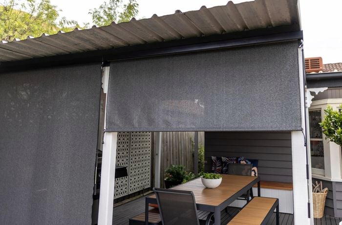 Halfway opened outdoor roller blind.