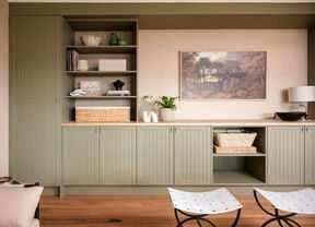 Cabinet indoors with timber top, timber shelving with artwork in the back ground