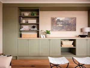 Cabinet indoors with timber top, timber shelving with artwork in the back ground