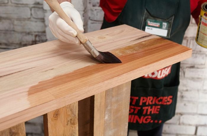 A timber bar counter being varnished