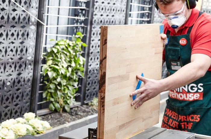 Person placing two bits of timber together.