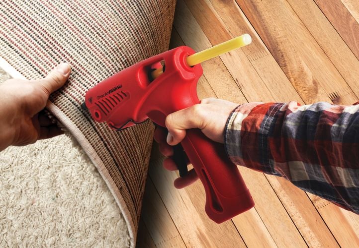 A Tradeflame hot glue gun used to mend a rug
