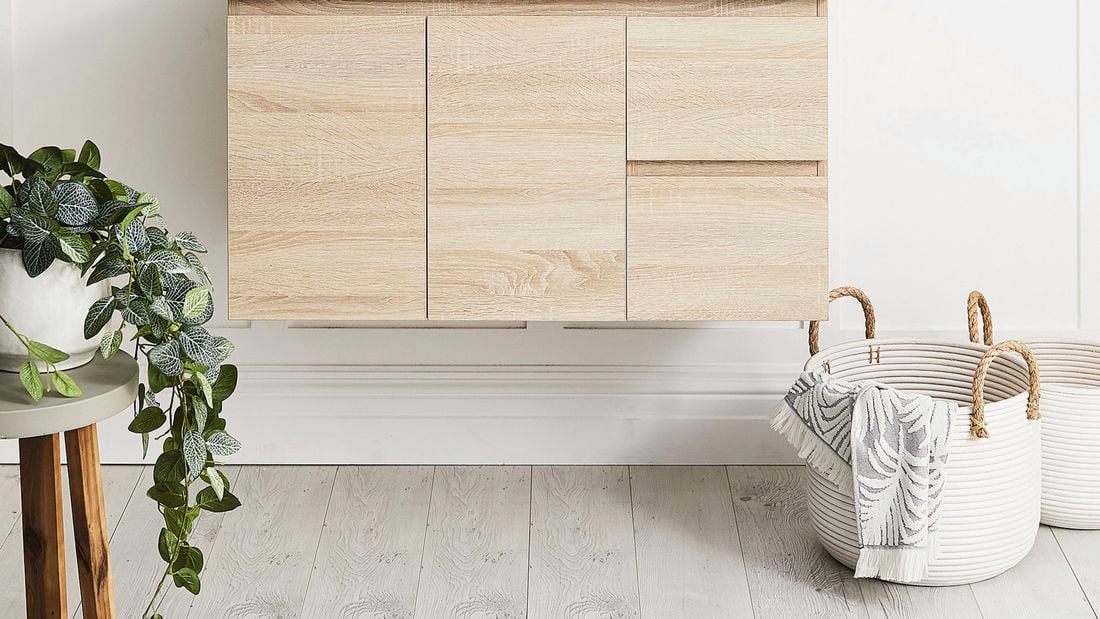 Bathroom basket, pot plant and light timber cupboard.