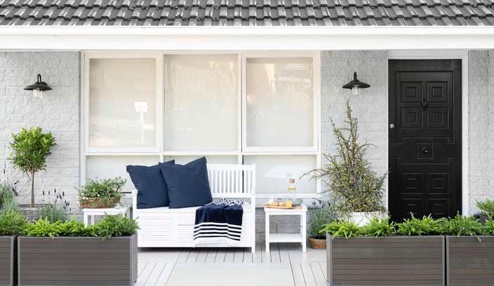 Front of house with bench seat and planter boxes.