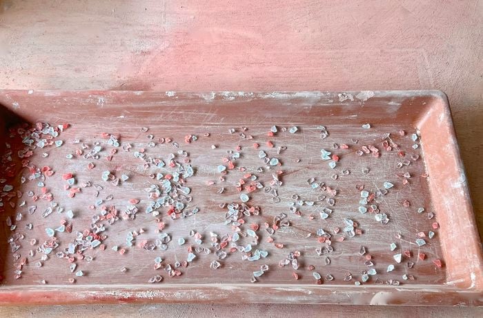 Crushed mosaic glass scattered on a rectangle mould