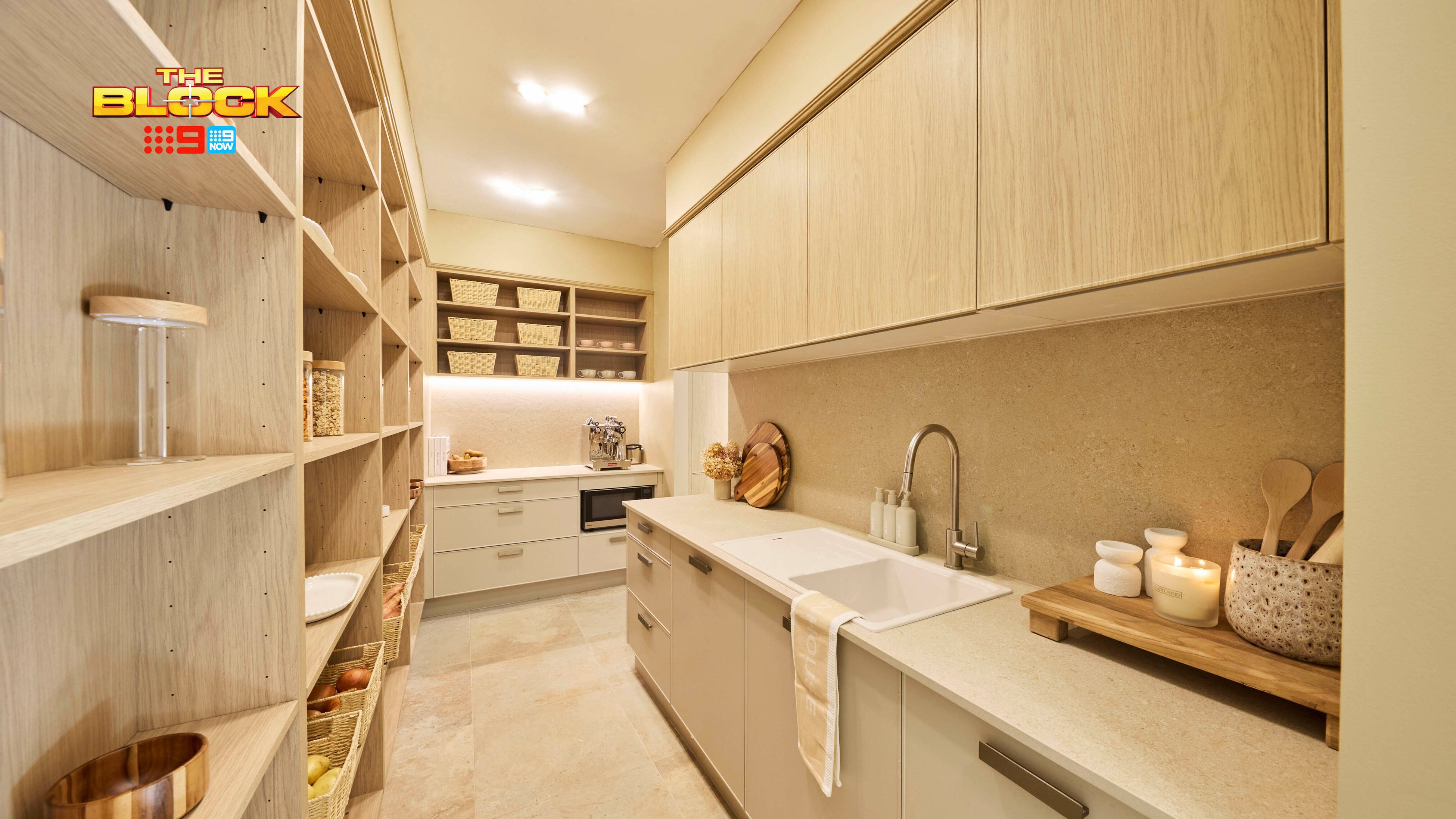 Butler’s pantry from The Block with ample shelving, stone benchtops, sink, and integrated cabinetry.