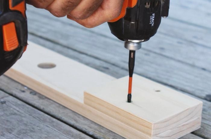 A crossbar being assembled for a dowel Christmas tree