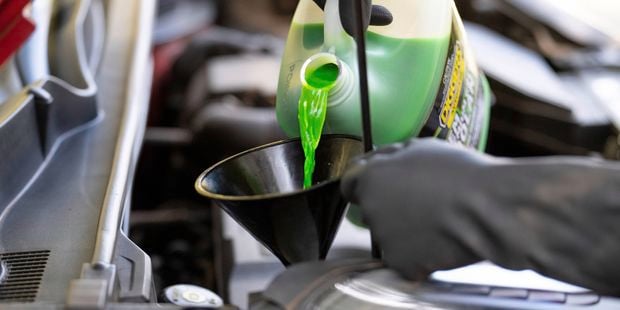 Top up the coolant through a funnel