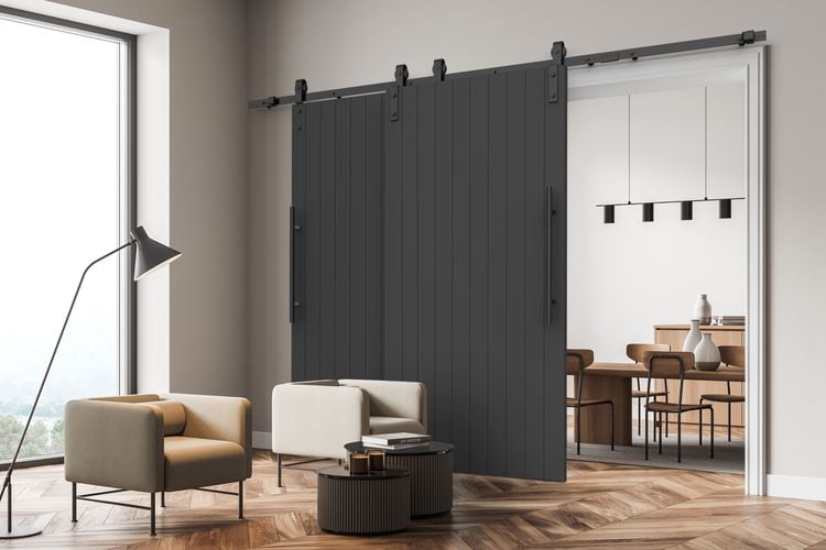 Living room interior featuring Rolltrak Matte Black Bypass Side Mount Barn Door Track and 600mm Matte Black Round Double Pull Handle.