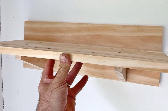 A wooden shelf added to a wall
