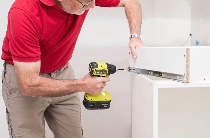 Attach the drawer guides on each drawer side