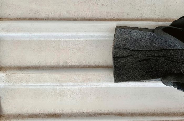 Sanding sponge on garage door.