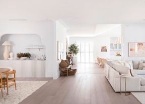 Hampton style home, inside with timber floors, white walls  and cream lounge suit