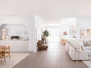 Hampton style home, inside with timber floors, white walls  and cream lounge suit