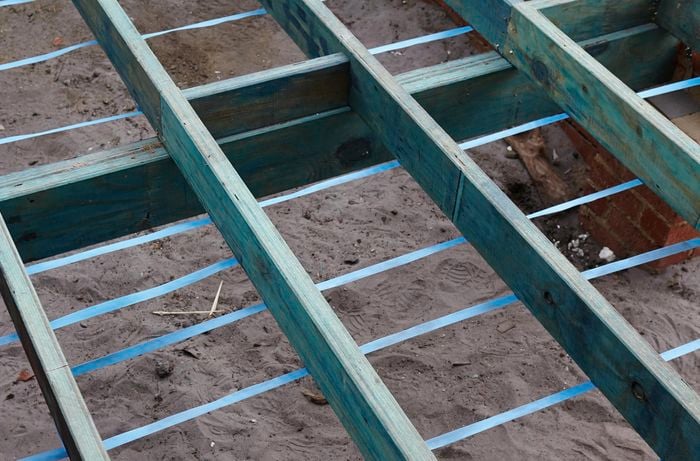 Floor joists with lengths of strapping underneath at regular intervals
