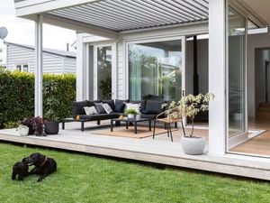 Outdoor alfresco area with black outdoor steel setting