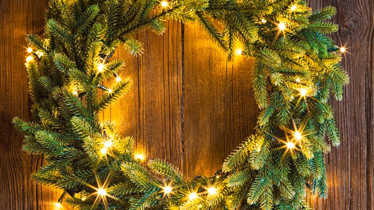 Christmas wreath on a timber front door with fairy lights