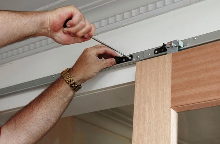 Center bump stops being installed on the tracks of a set of sliding doors