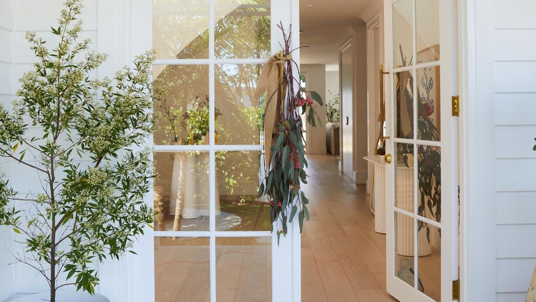 Homemade plant decorations hanging on a front door handle