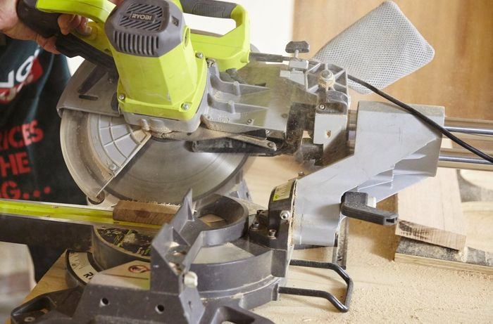 A piece of timber being cut on an angle with a drop saw