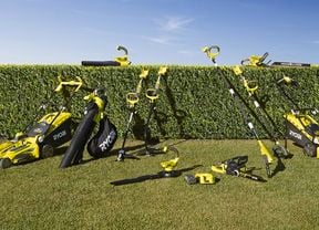 A range of RYOBI equipment and power tools laid out on a lawn.
