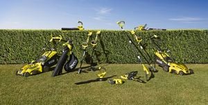 A range of RYOBI equipment and power tools laid out on a lawn.