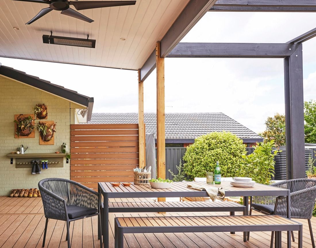 A wooden deck with outdoor furniture.