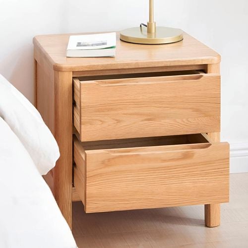 This natural oak bedside table features two smooth drawers and a soft rounded-edge design for a clean, modern look.