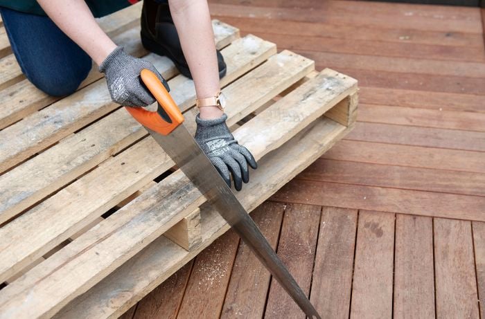 A pallet being dismantled with a saw
