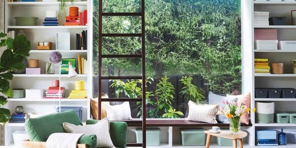 Room with storage shelves, sofa and a big window