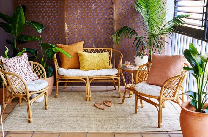 Indoor balcony with wicker chairs and assorted pot plants