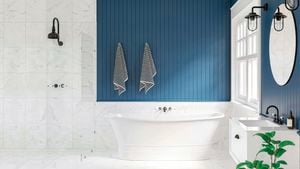 Bathroom with blue panelled wall, white marble tiles and black accessories.