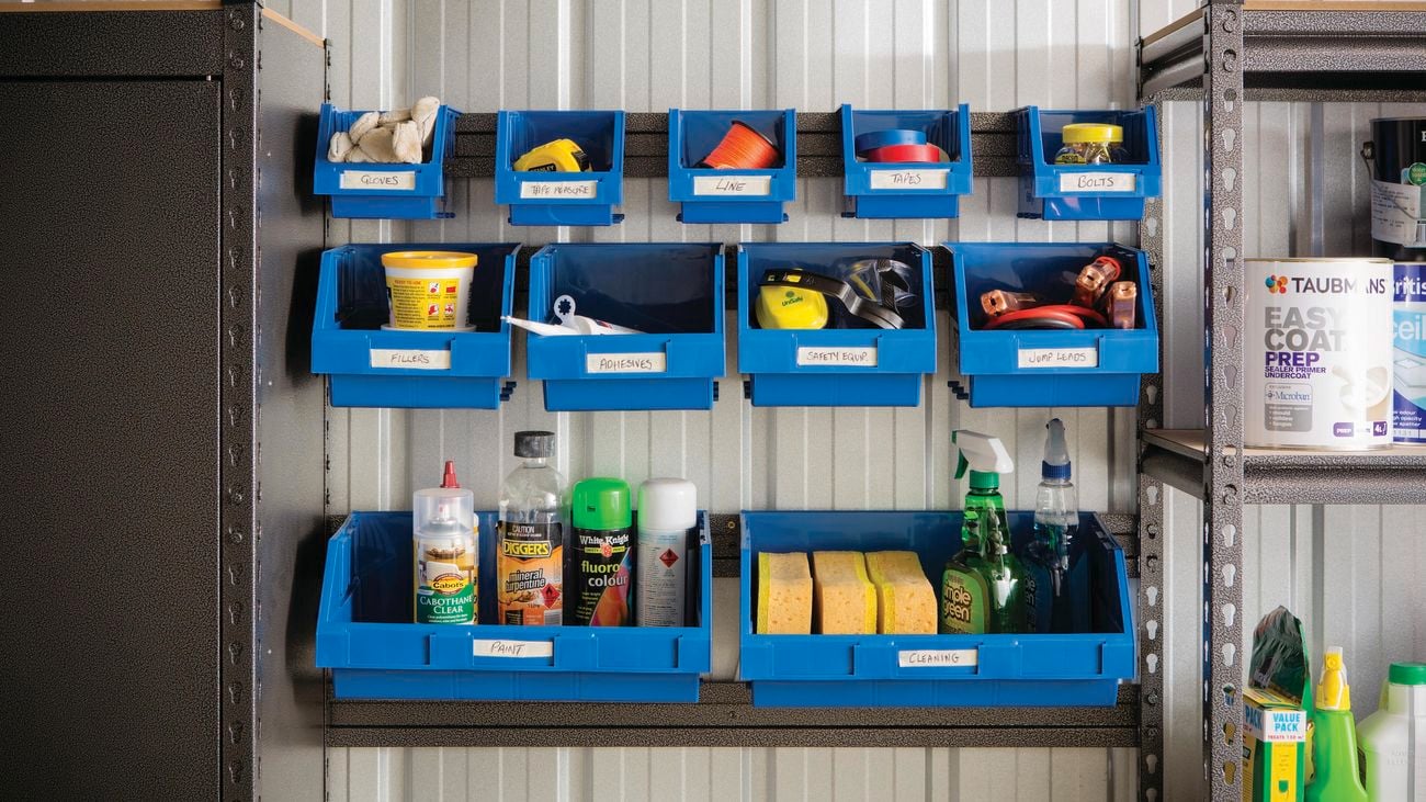 Garage shelving with assortment of things hung up.