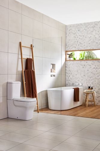 Bathroom with white toilet and bath and timber towel rack