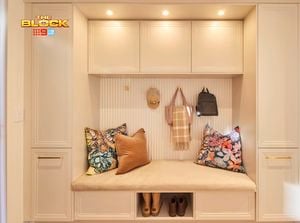 Mudroom nook from The Block with built-in bench, overhead cupboards, cushions, hooks, and shoe storage.