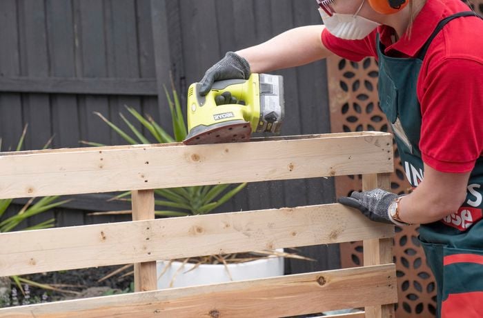 A pallet being sanded down