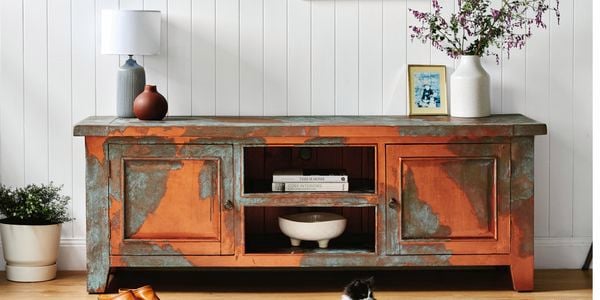Multi coloured tv unit placed in the hallway 