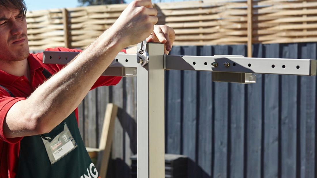 Attaching the universal bracket to the post of a retractable clothesline.