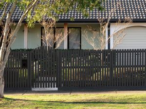 Freshly painted picket fence with a smooth professional finish​