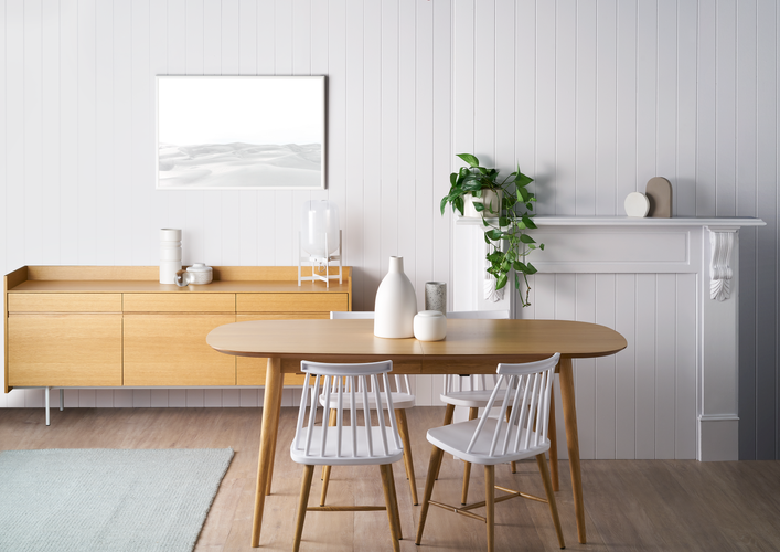 White painted wood panelled living area with Scandinavian-style wooden furniture