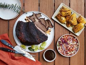 A plate of brisket, served with chilli pickle slaw and grilled corn