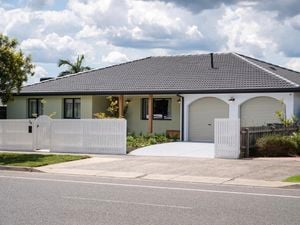 Front of house with a picket fence at the front of it