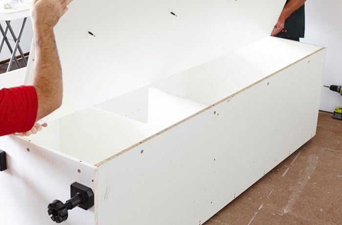Person connecting panels of cupboard