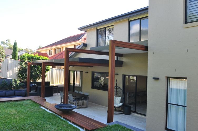 Timber support beams extending from the back entrance of a house