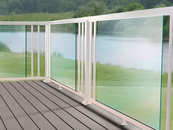 Custom white balustrade system on a deck with balusters and glass panels.