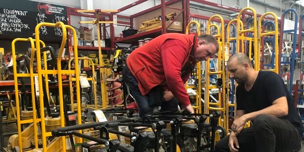 A Bunnings team member assisting a customer in a hire shop