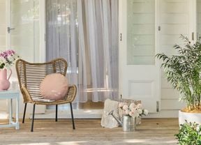 An outdoor furniture setting in a spring garden